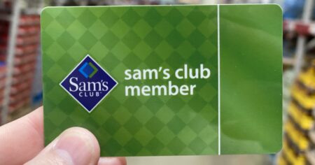 TheFreebieGuy's hand holding a Sam's Club Membership card - Sam's Club Membership deals