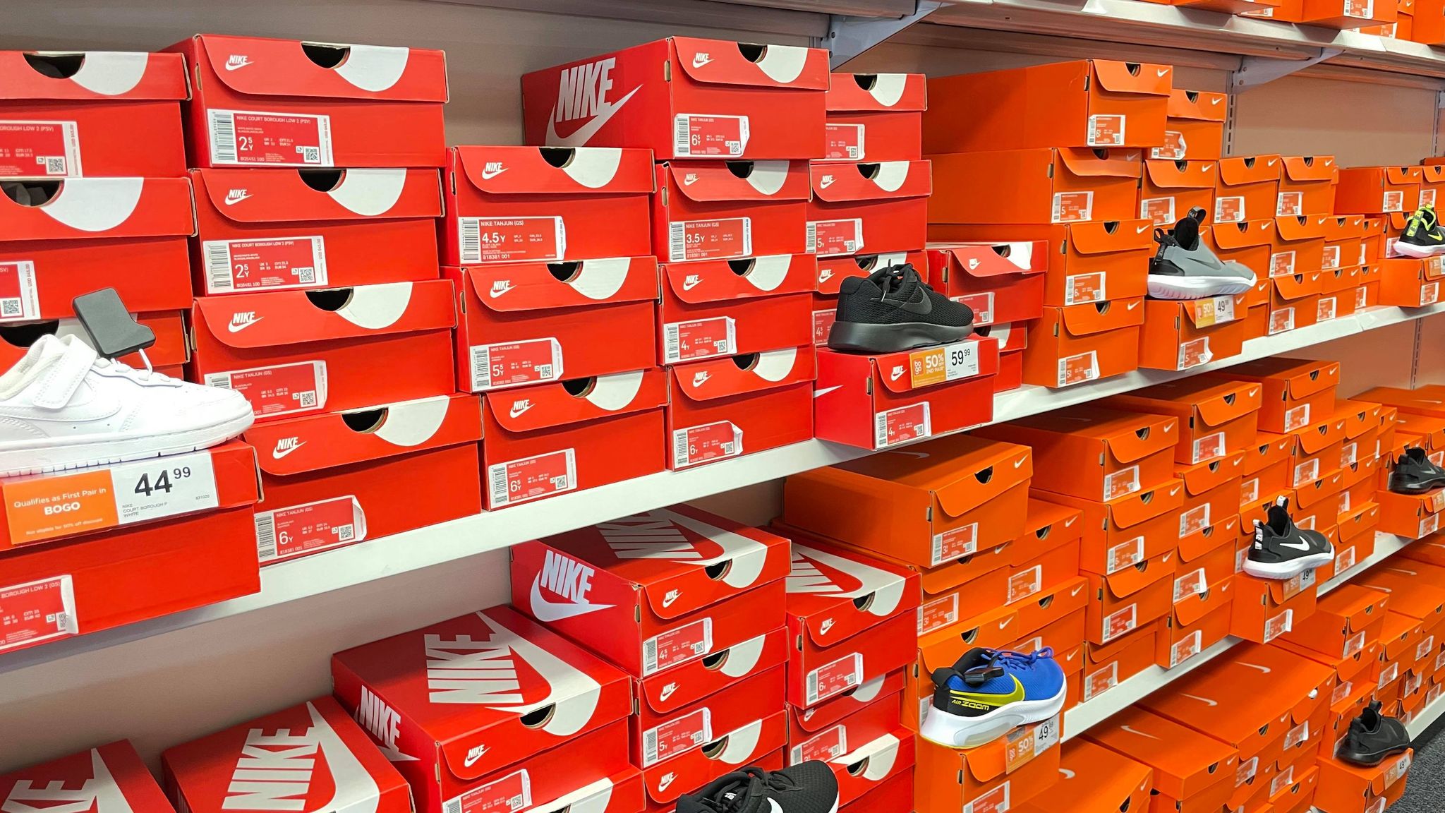 Nike shoe boxes on shelves at a store