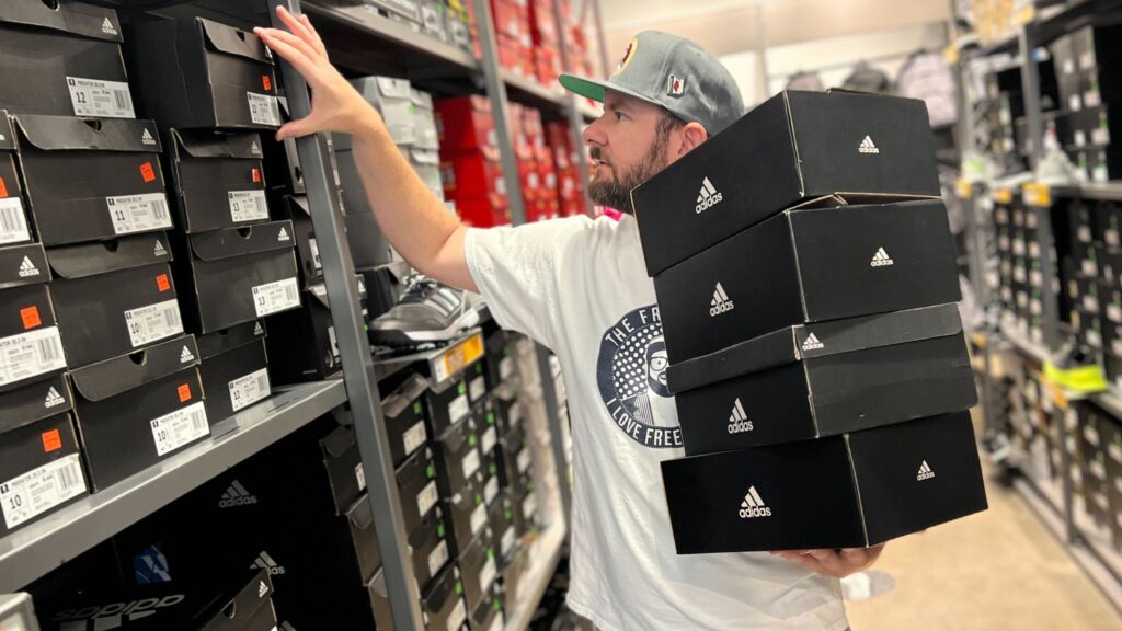 Kendall holding Adidas shoe boxes