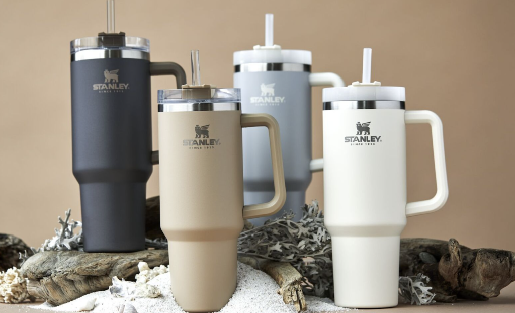 four Stanley tumblers in neutral colors