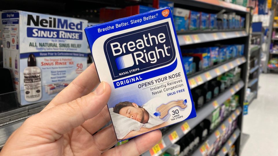 hand holding a breathe right strip package