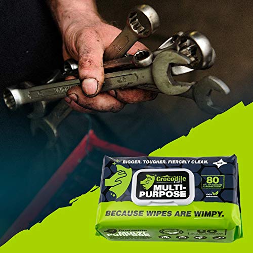 man holding wrenches above package of crocodile cloth household wipes