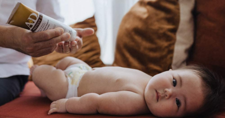 baby with bottle of a+d ointment
