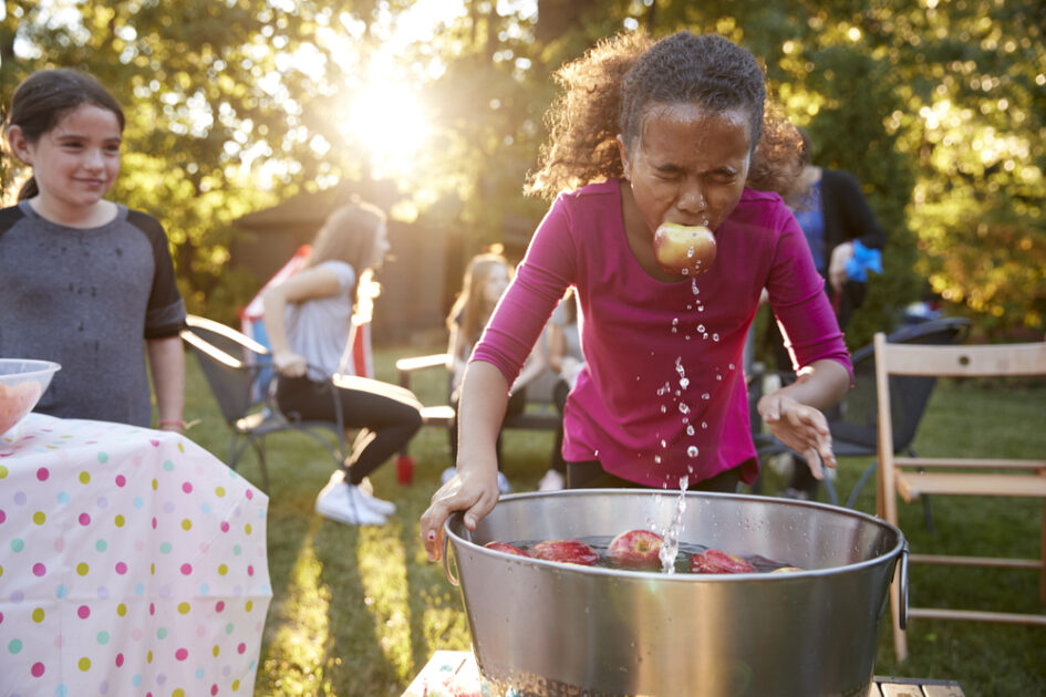 girl bobbing for apples