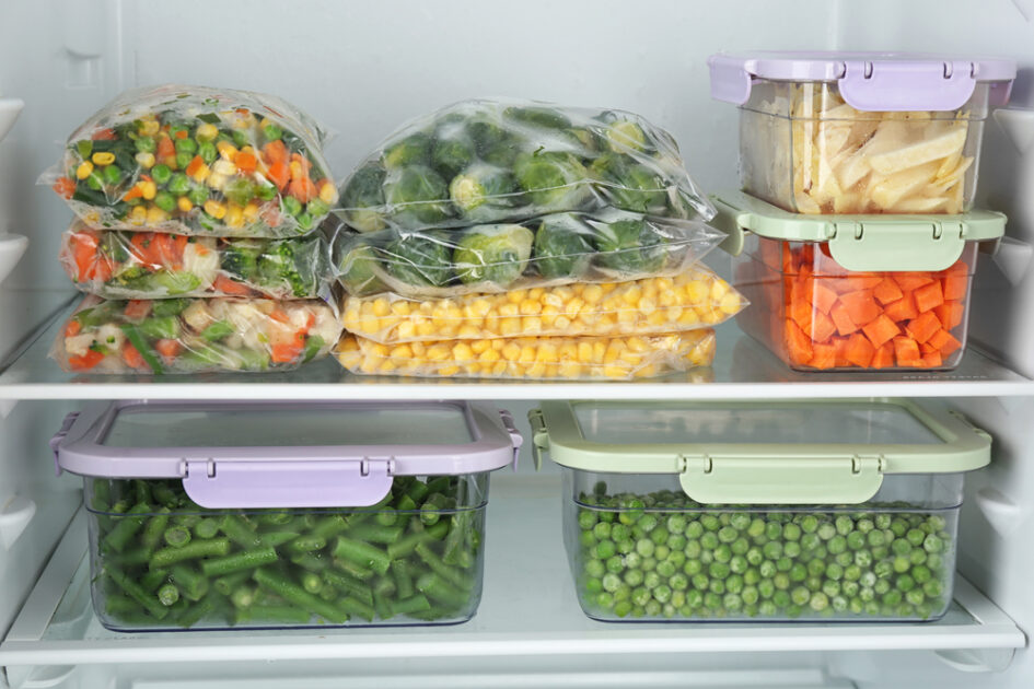 freezer with frozen vegetables in containers