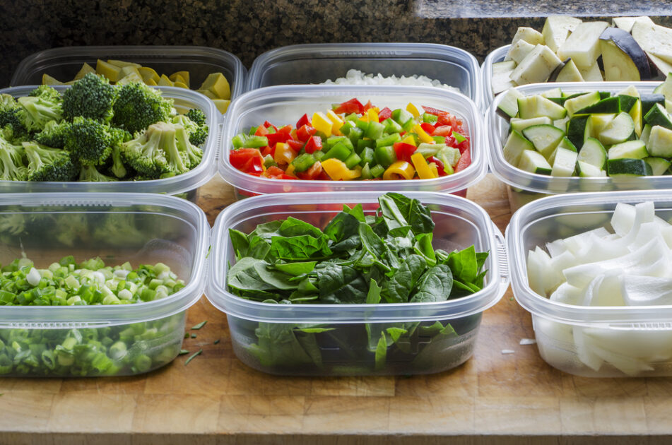 prepped food in plastic containers on a counter