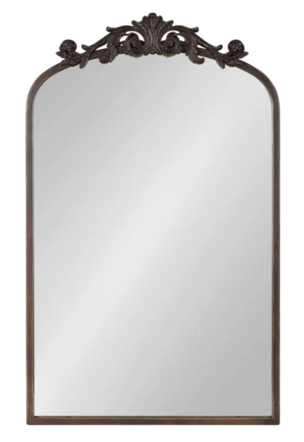 mirror with gold edges and flourish on the top