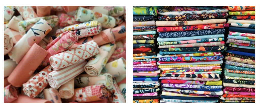 rolls of fabric next to stacks of fabric