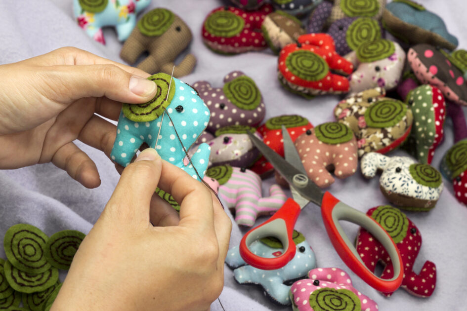 hand sewing small elephants