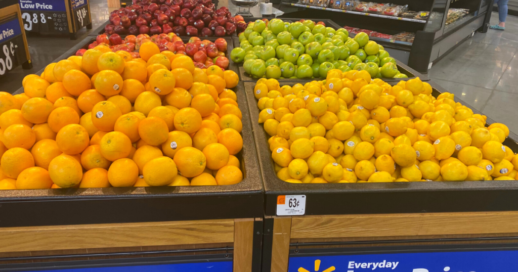 oranges, apples, and lemons in bins at a store