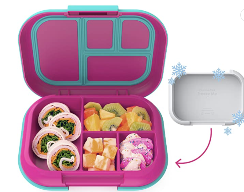 Bento box with food in it and a small container next to it