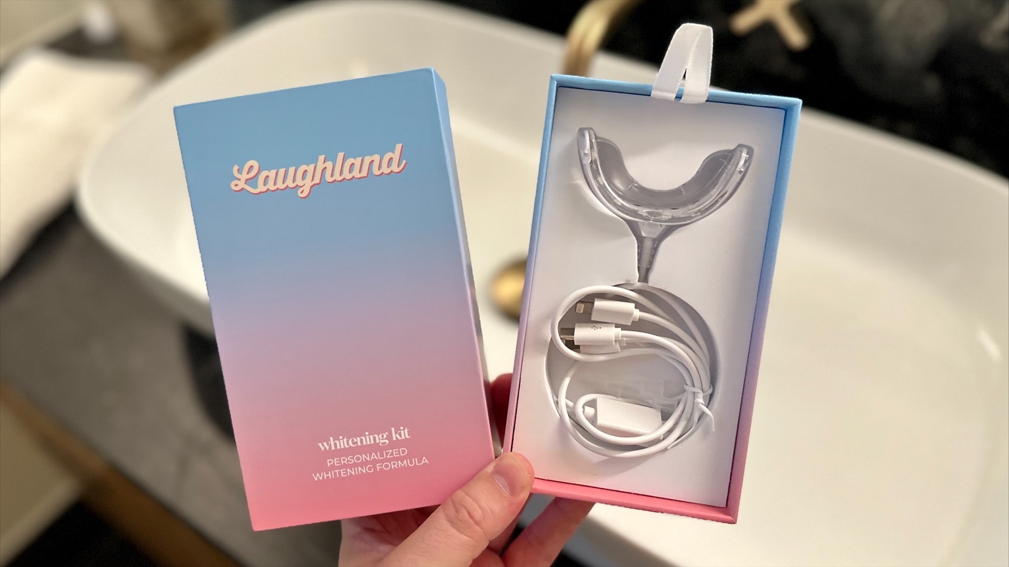 hand holding Laughland whitening kit