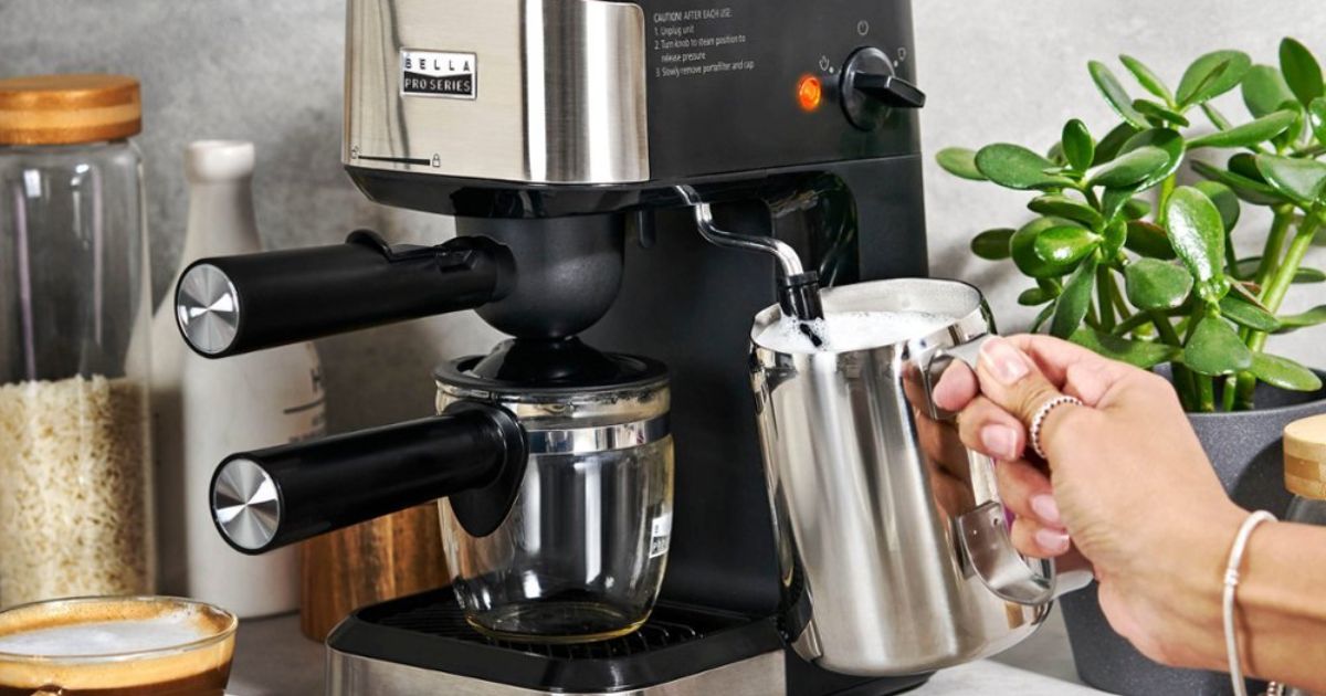 Bella Espresso Machine hand holding a cup under a milk frother