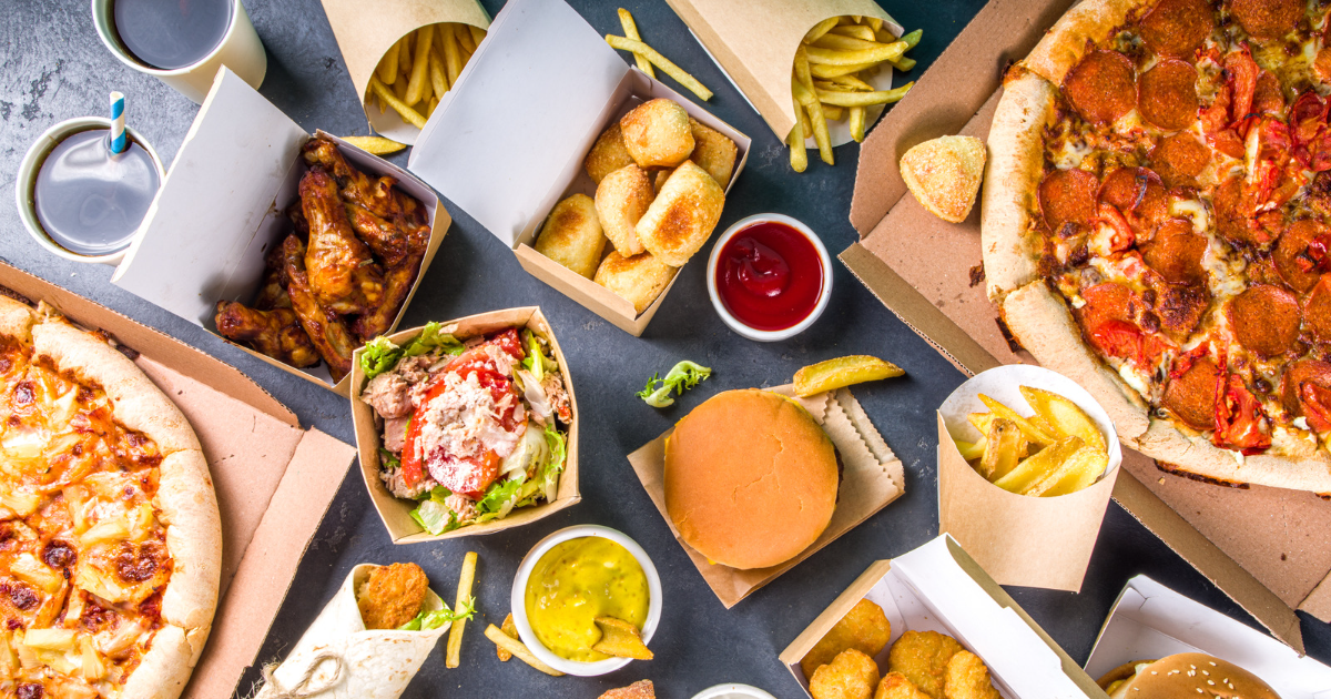 table with lots of fast food items laying on it