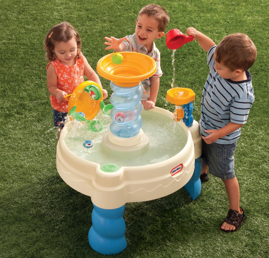kids playing with a water table