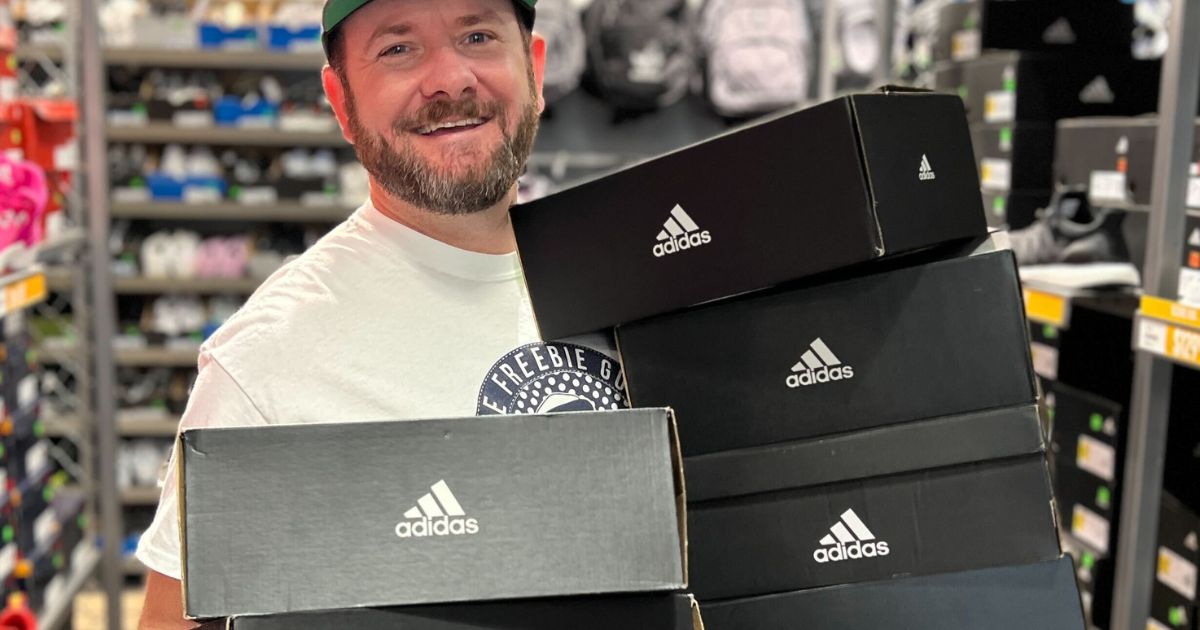 Kendall holding Adidas shoe boxes in-store