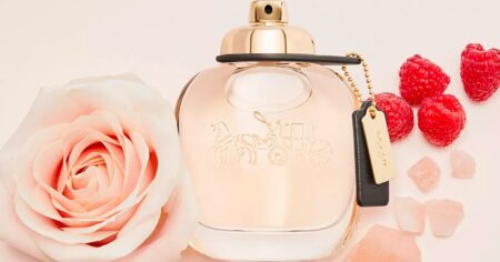 Coach perfume bottle with roses around it