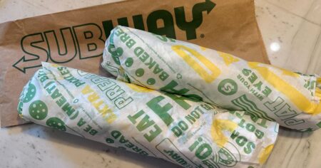two subway footlong sandwiches wrapped in subway-brand paper - subway deals & promo codes