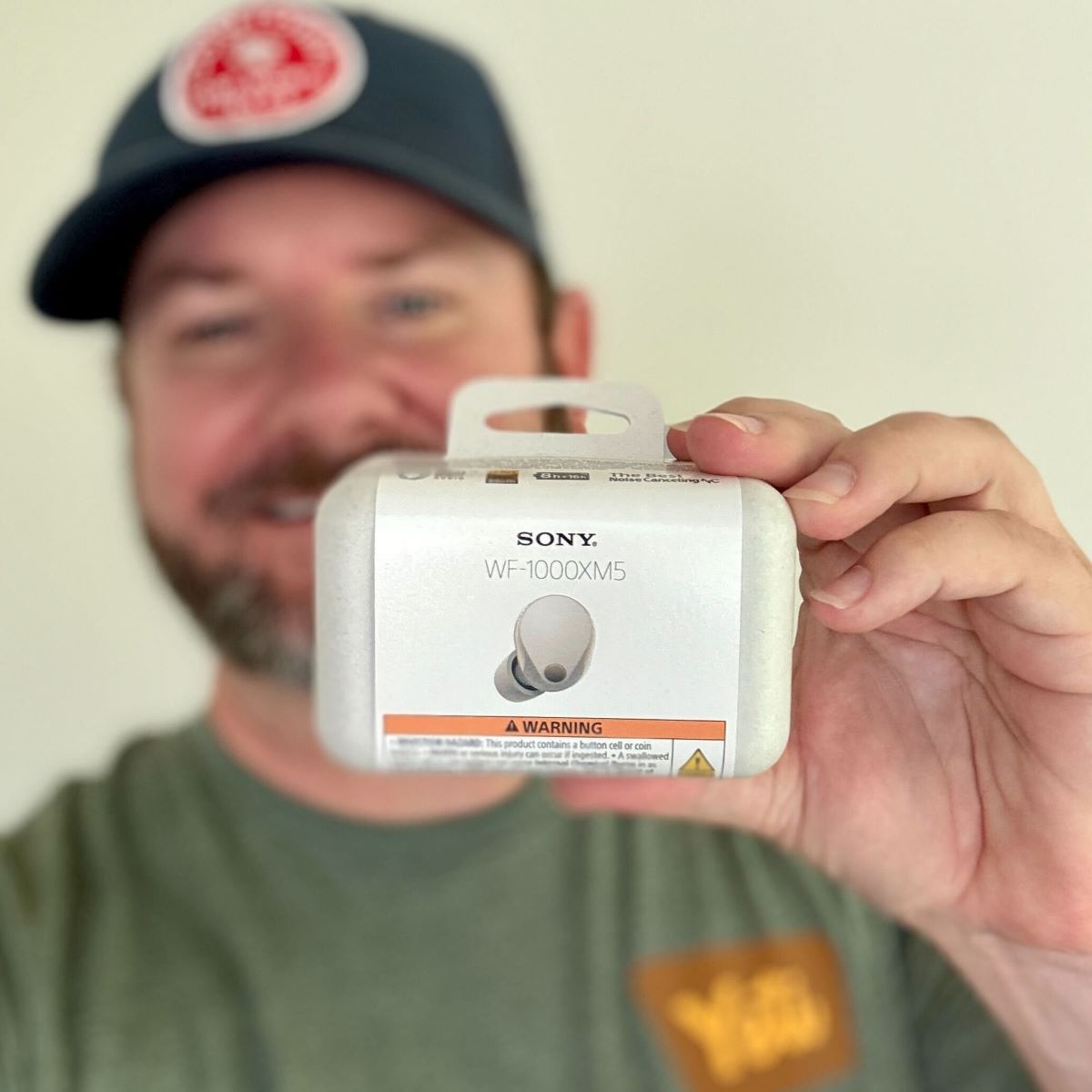 Sony WF 1000XM5 The Best Truly Wireless Noise Canceling Earbuds man holding a pair of Sony earbuds