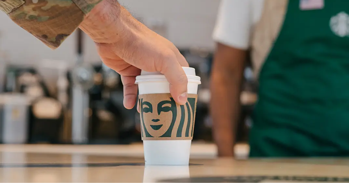 Free Coffee at Starbucks An image of a member of the military holding a Starbucks coffee