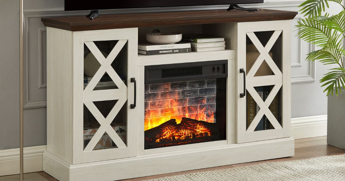 White TV stand with a fireplace in the middle and a TV on top