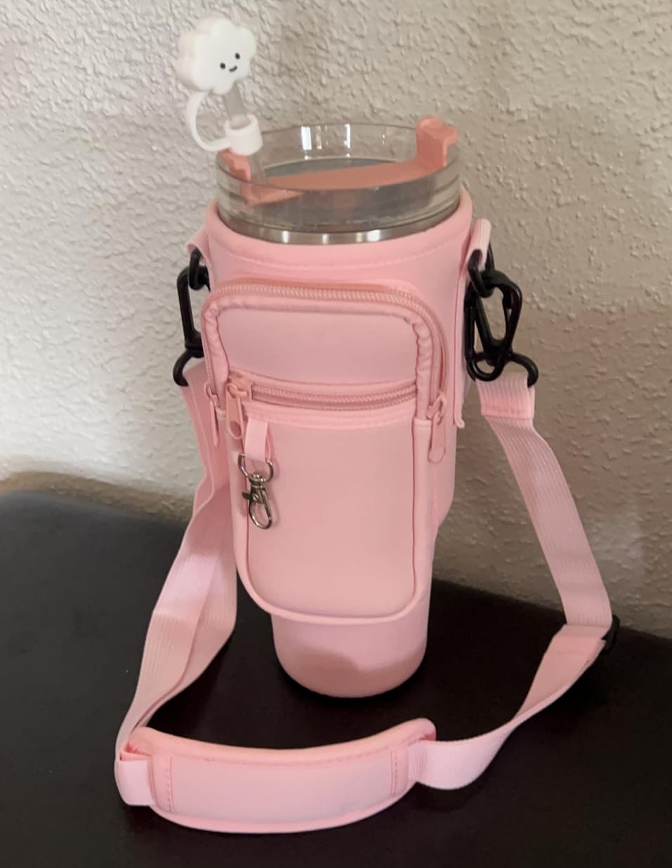 tumbler in a pink carrier bag with a cloud straw topper