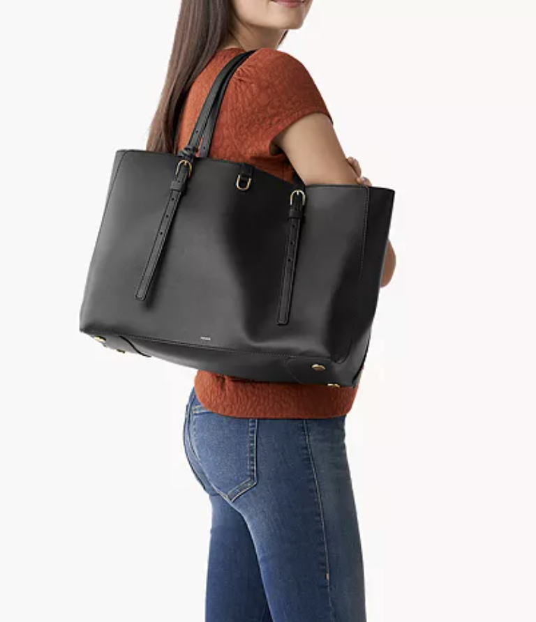 lady holding black leather tote - Fossil tote bag deals