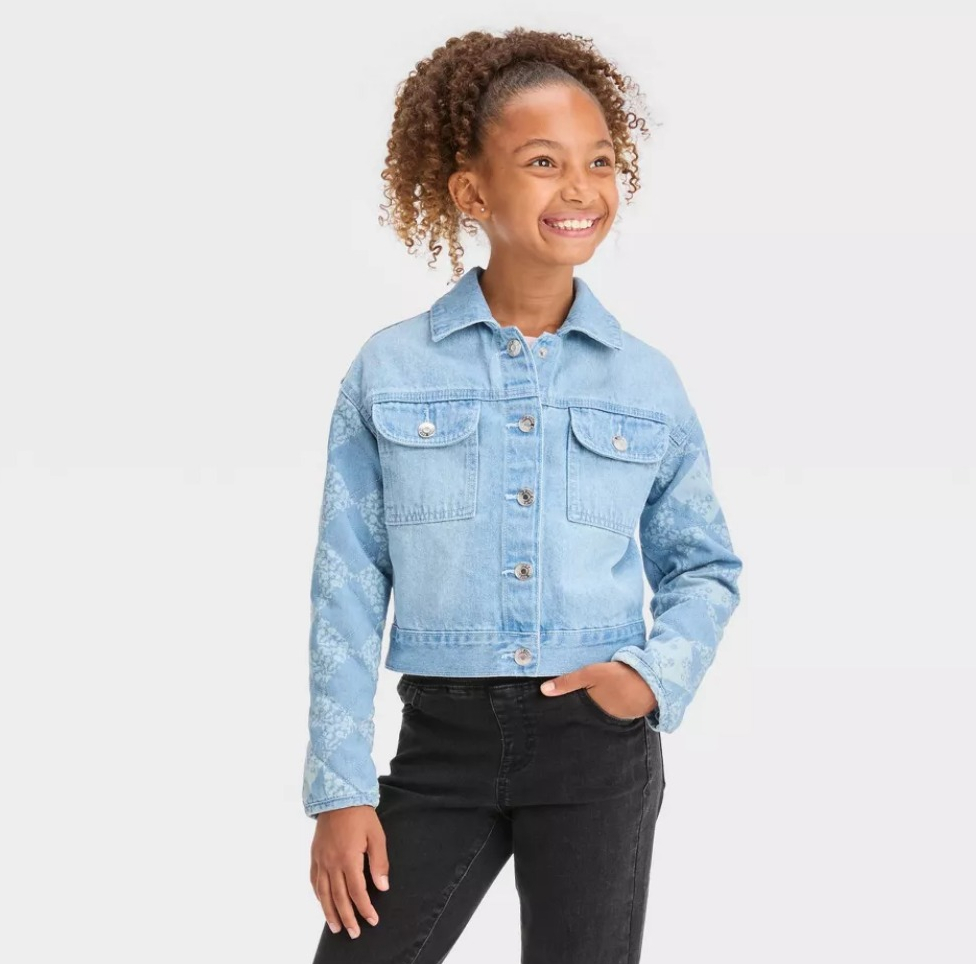 girl wearing a jean jacket and black jeans