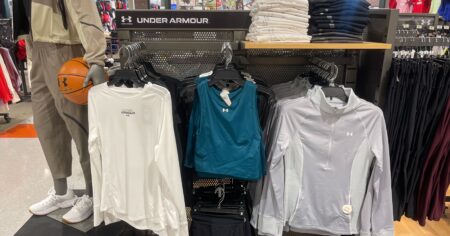 under armour apparel on hangers both jackets, sports bras, and mannequin in outfit