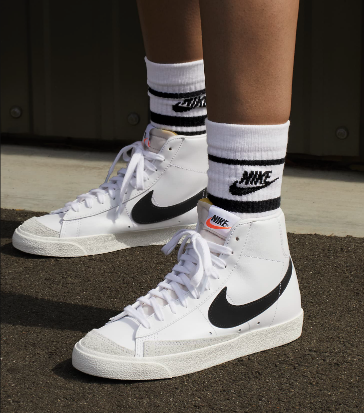 Person wears black and white Nike Blazers