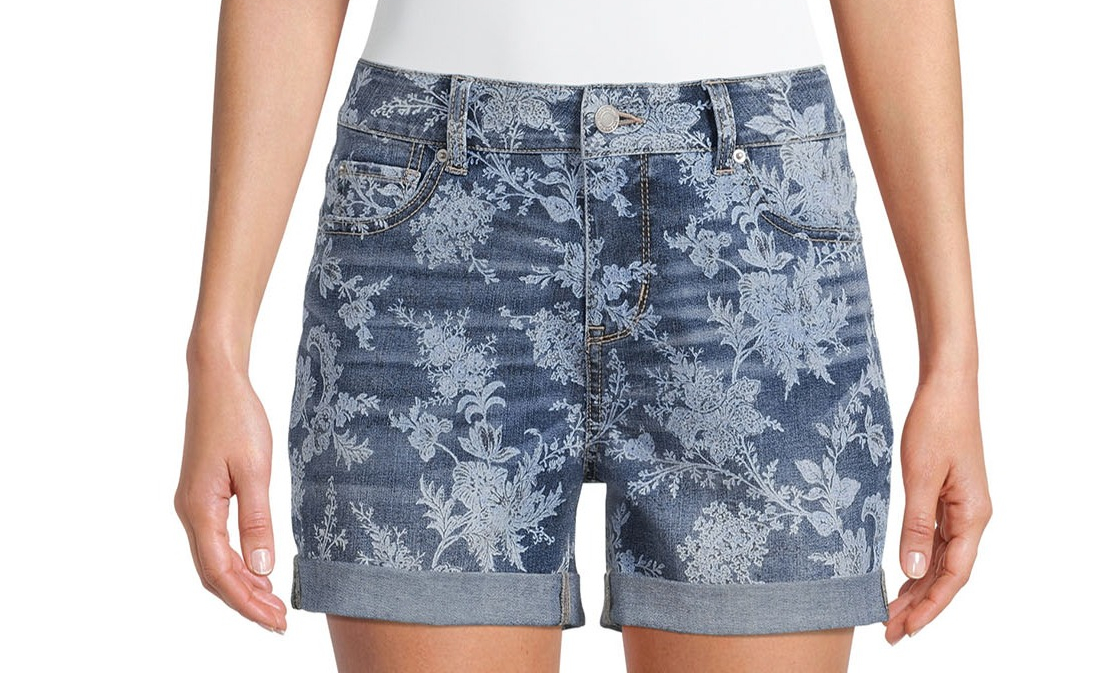 woman wearing denim shorts with a floral pattern on them