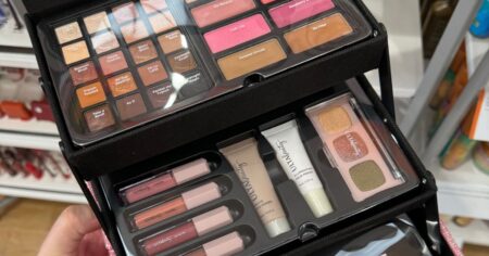 hand holding an ULTA beauty box filled with cosmetics