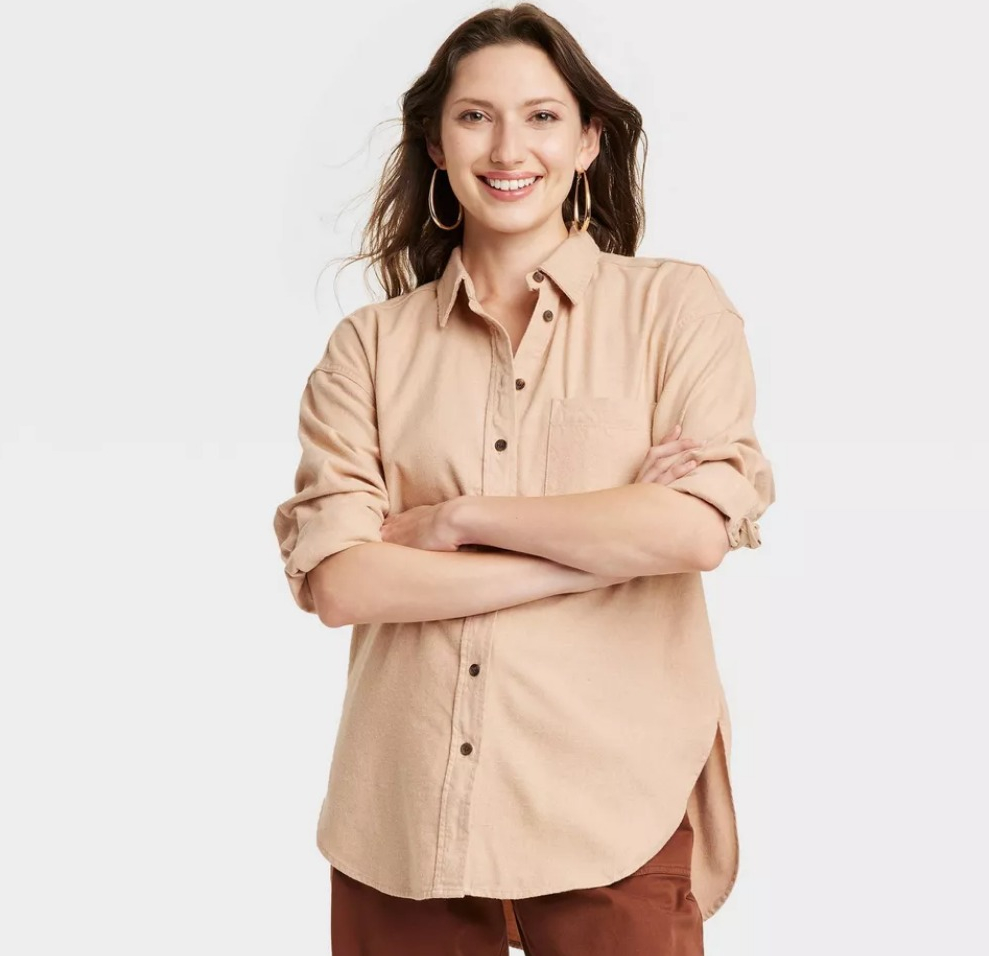 woman smiling at the camera with her arms crossed