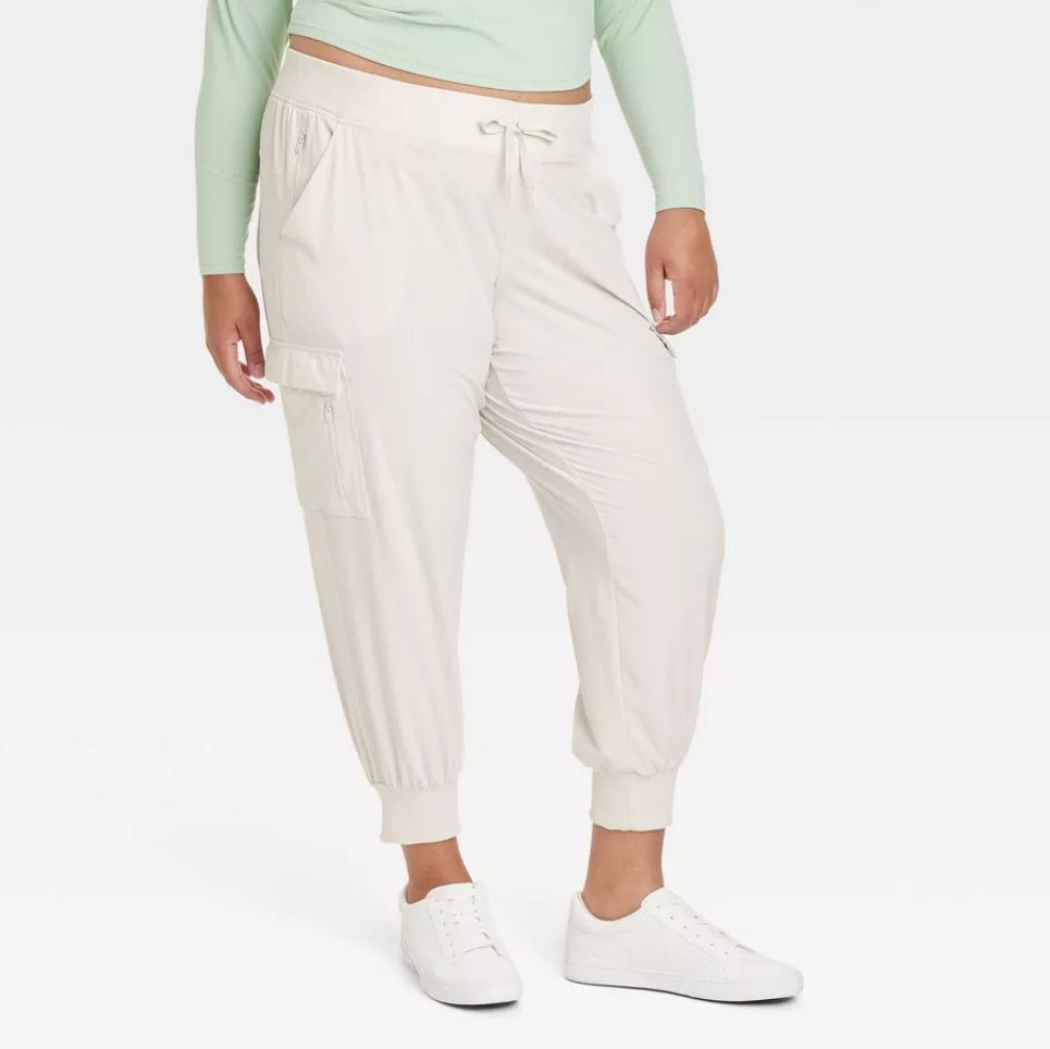 woman wearing white cargo pants and a teal shirt