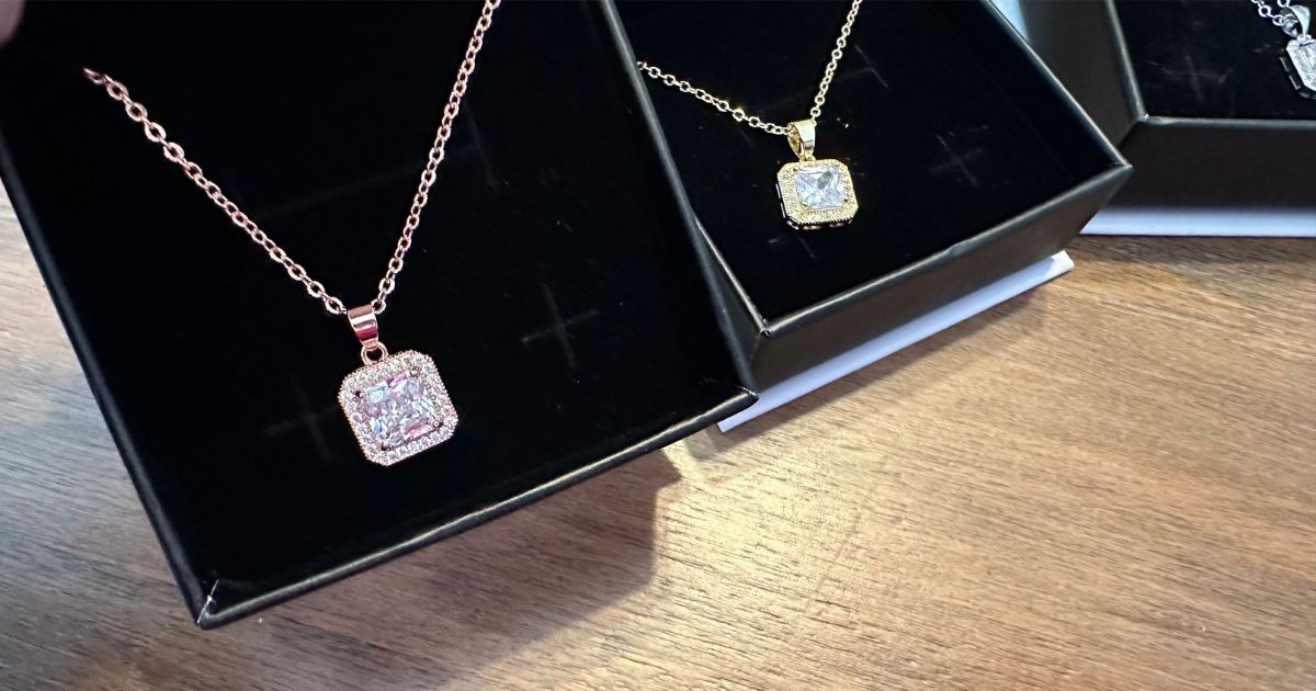 three necklaces in boxes 