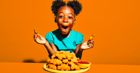 girl with a plate of chicken nuggets