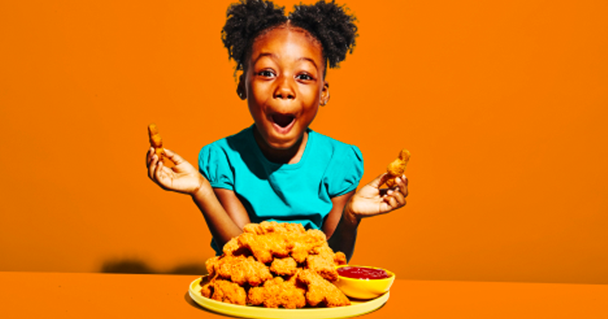 girl with a plate of chicken nuggets