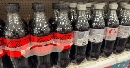 bottles of coke soda on a shelf