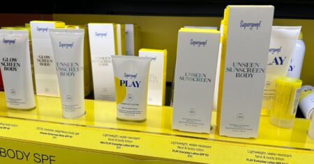 row of Supergoop products on a shelf