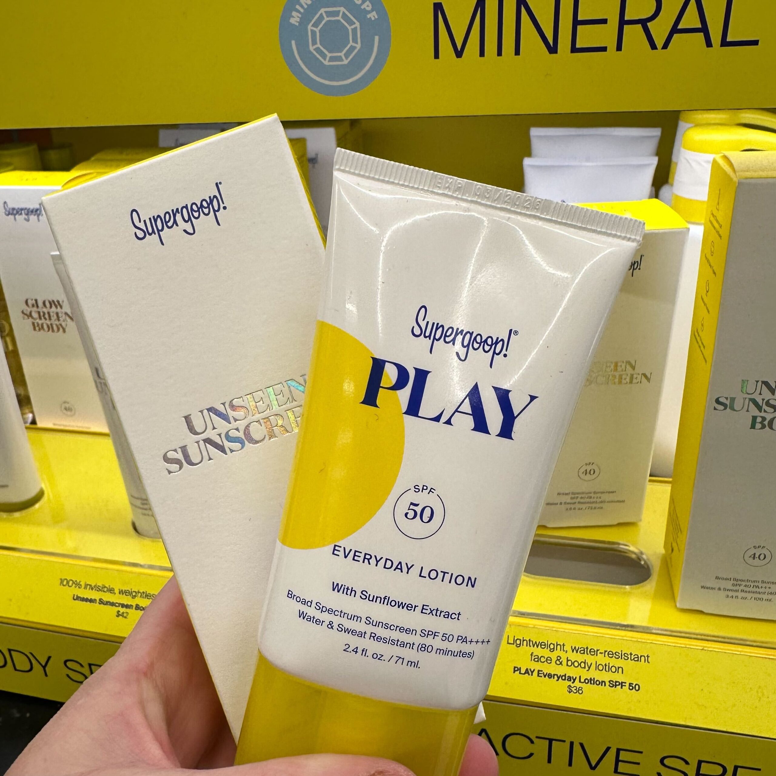 hand holding a supergoop sunscreen