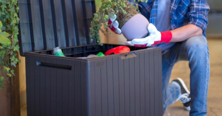 man kneeling next to Keter Deck Box