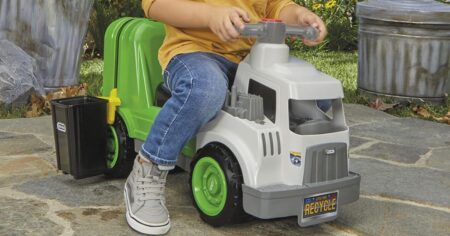 boy riding on a toy garbage truck