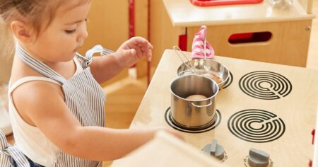 girl playing at a toy stove