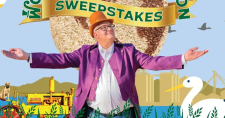 man in purple jacket with arms open