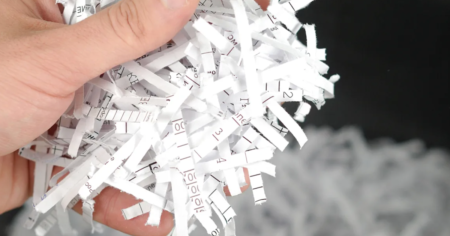 shredded paper in hand