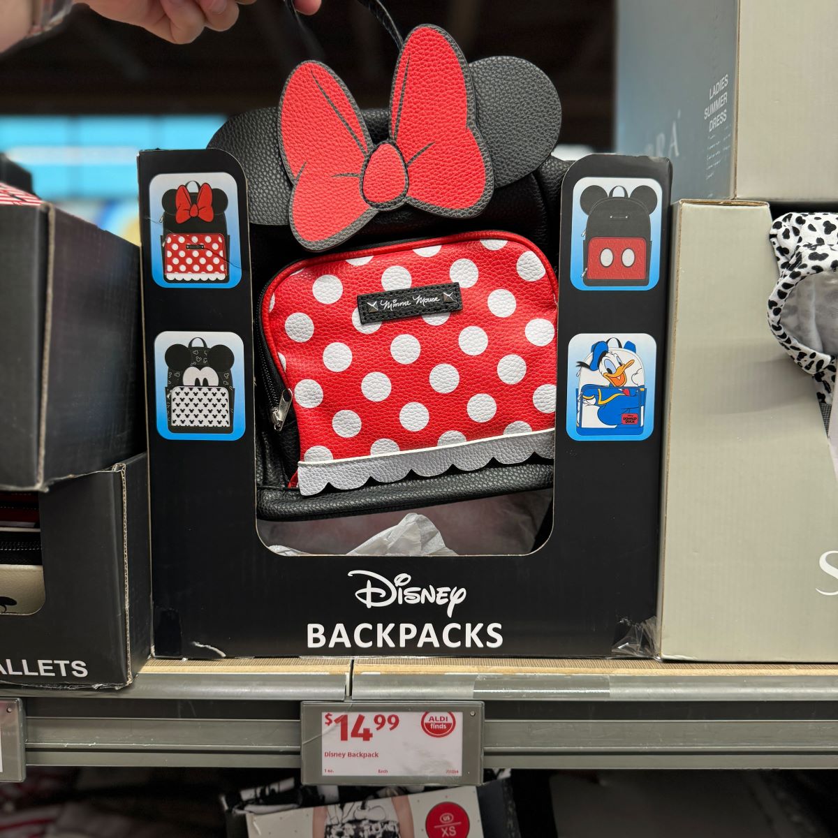 Disney Backpacks hand holding a Disney backpack