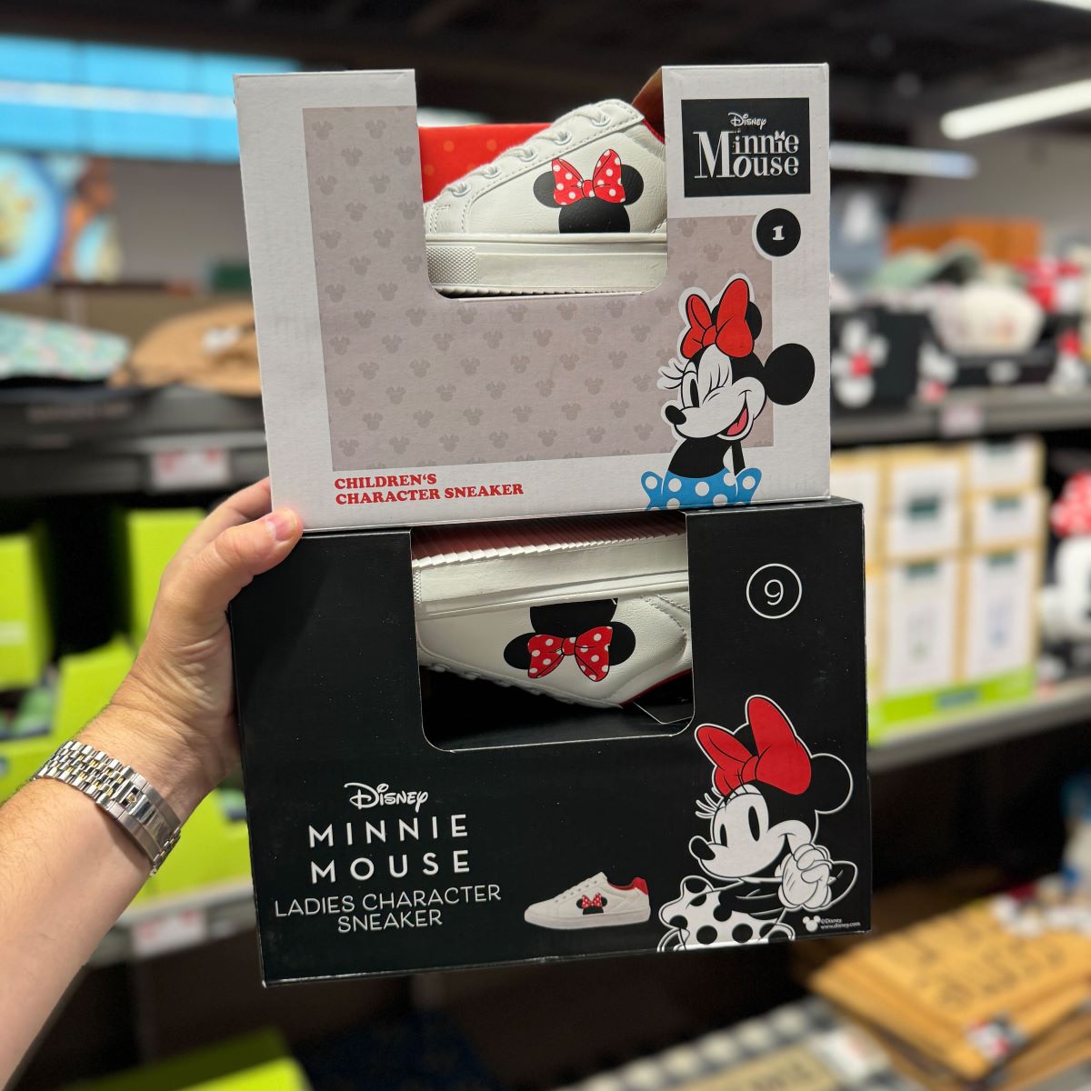 Disney Character SHoes hand holding two boxes of Disney shoes