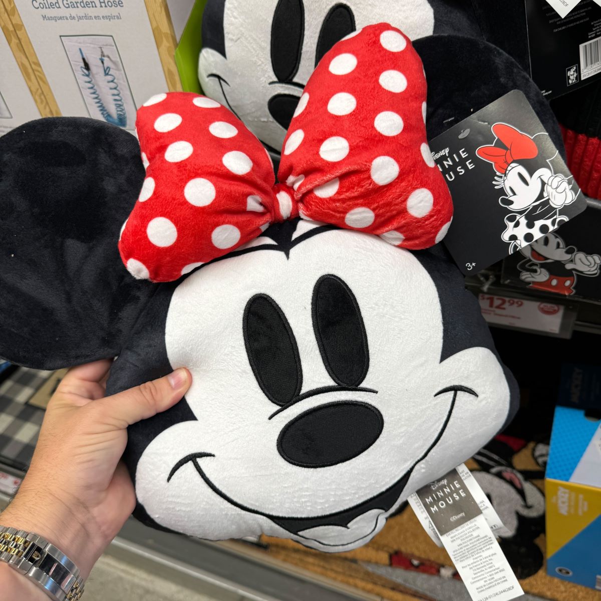 Disney Pillow hand holding a Minnie Mouse pillow
