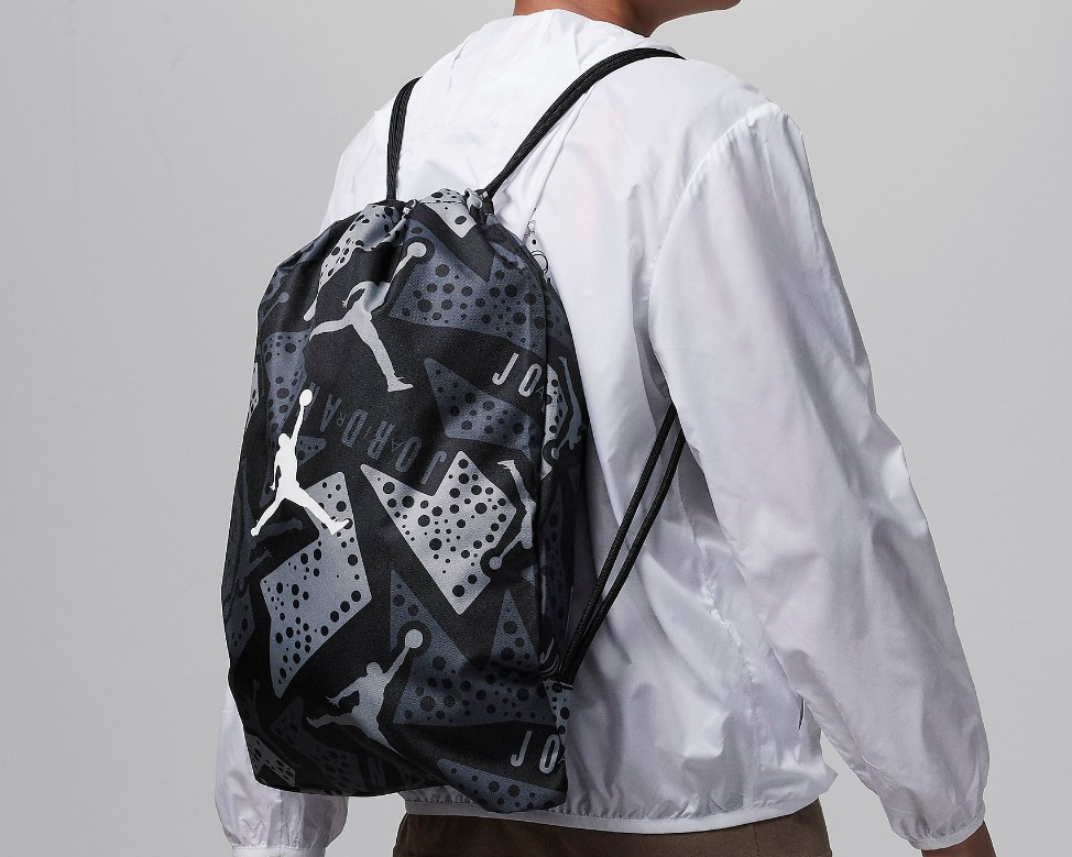 boy wearing a Jordan gymsack on his back