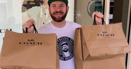 man holding two Coach bags